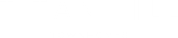 A green sign with white text that reads "Titan Hill Townhomes".